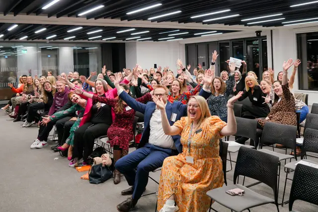 The audience cheering at the Q4 2024 launch in London, hosted by Shoosmiths